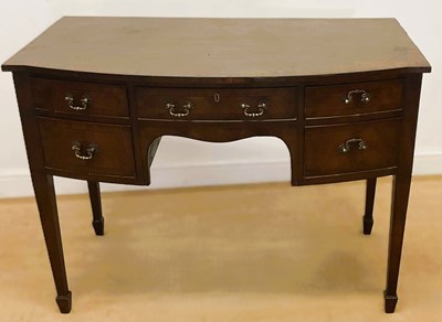 Lot 876 - A mahogany bowfronted desk with central drawer,...