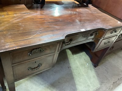 Lot 765 - A mahogany desk with central drawer, flanked...