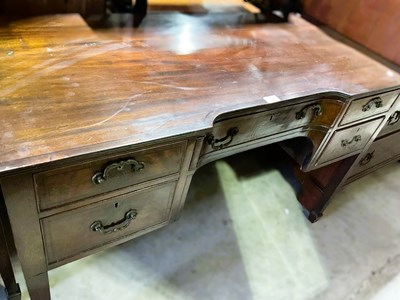 Lot 878 - A mahogany desk with central drawer, flanked...