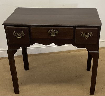 Lot 764 - A mahogany three drawer lowboy, with a central...