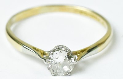 Lot 711 - An 18ct yellow gold ring set with a diamond in...