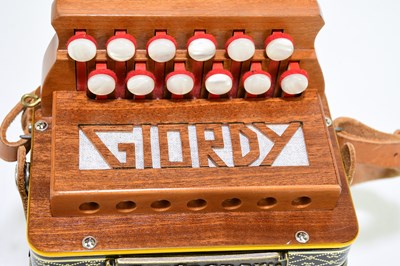 Lot 1062 - CASTAGNARI; a Giordy melodian, with soft case.