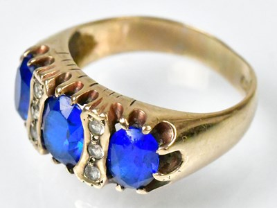 Lot 747 - A 9ct yellow gold ring set with three blue...