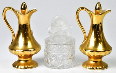 Lot 143 - CROWN DEVON; two gilt finish lidded ewers,...