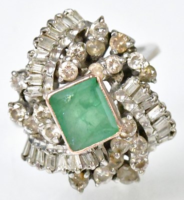Lot 763 - A white metal ring set with a central emerald,...