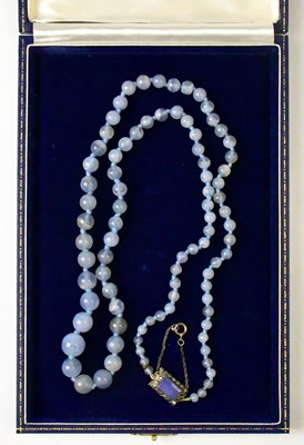 Lot 826 - A blue jade necklace with graduated beads and...