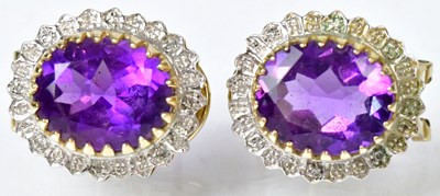 Lot 835 - A pair of 9ct yellow gold earrings set with...