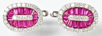 Lot 840 - A pair of silver earrings set with red and...