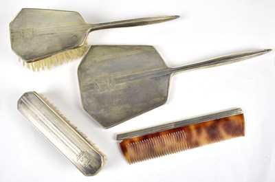 Lot 1133 - DANIEL MANUFACTURING CO; a George VI hallmarked silver Art Deco style four piece dressing table set
