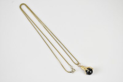 Lot 480 - A 9ct gold and polished hardstone pendant...