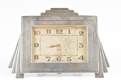 Lot 110 - An Art Deco white metal eight day mantel...