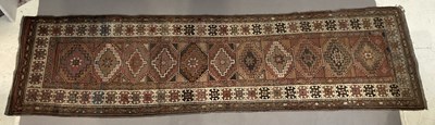 Lot 1413 - An Eastern runner with stylised lozenge motifs...