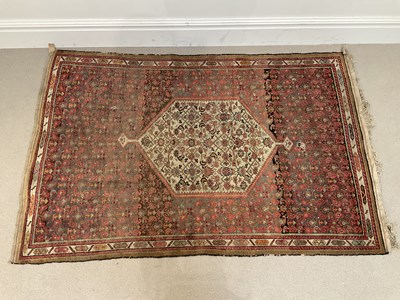 Lot 299 - An early 20th century rug centrally decorated...