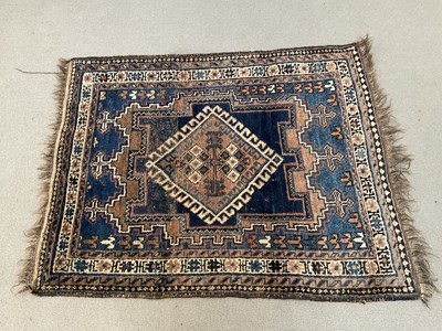 Lot 297 - An Eastern prayer mat with stylised lozenge on...