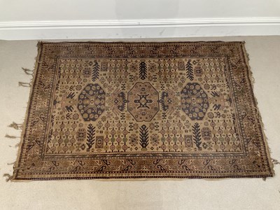 Lot 1415 - An Eastern hand knotted woollen rug on brown...