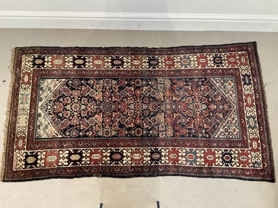 Lot 1390 - A decorative Eastern rug with stylised motifs...