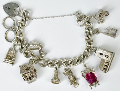 Lot 778 - A hallmarked silver charm bracelet with a...