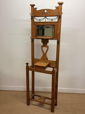 Lot 796 - An Arts and Crafts oak hall stand with a...