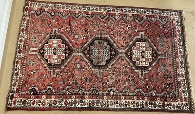 Lot 806 - A hand woven Persian rug decorated with three...