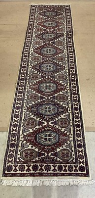 Lot 808 - A machine woven Persian style runner with a...