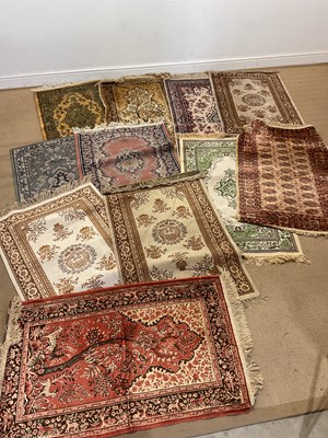 Lot 810 - Eleven machine woven small rugs, including...