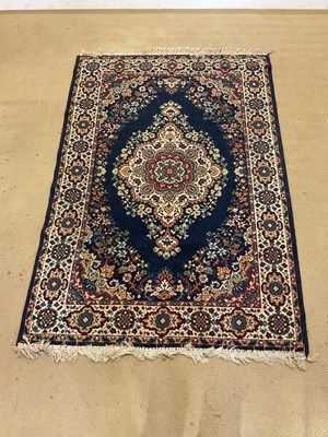 Lot 813 - A machine woven Oriental style rug deep blue...
