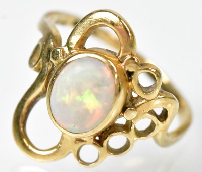 Lot 745 - A 9ct yellow gold ring set with an oval opal...