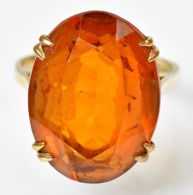 Lot 738 - A 9ct yellow gold ring set with a large orange...