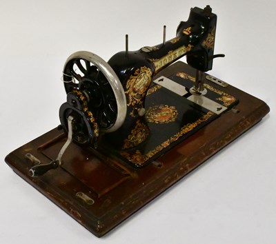 Lot 245 - JONES; a Portable Sewing Machine with wooden...