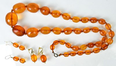 Lot 881 - An amber necklace of graduated faceted oval...