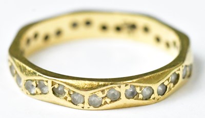 Lot 724 - An 18ct yellow gold eternity ring set with a...