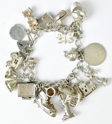 Lot 777 - A hallmarked silver charm bracelet with a...