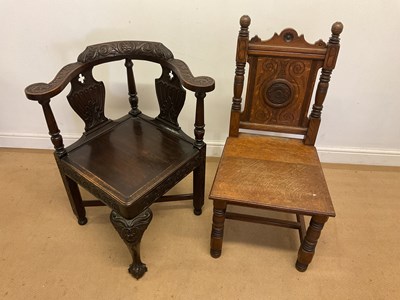 Lot 784 - Two oak chairs, comprising a carved oak corner...