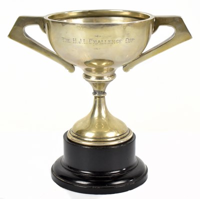 Lot 1132 - A George V hallmarked silver twin handled pedestal trophy cup