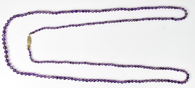 Lot 824 - A long necklace of graduated faceted amethyst...
