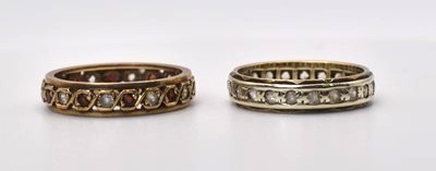 Lot 594 - Two 9ct gold eternity rings, the redstone ring...