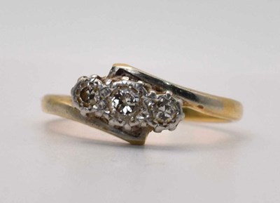 Lot 588 - A 18ct gold diamond three stone ring, size K,...