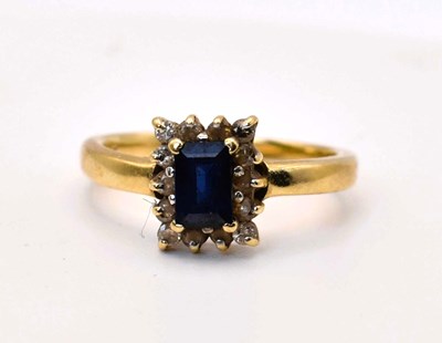 Lot 589 - A 14ct gold diamond and sapphire cluster ring,...