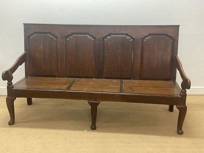 Lot 789 - A George III oak settle bench with four back...