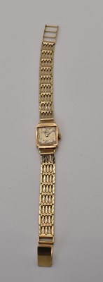 Lot 707 - An 18ct gold lady's wristwatch on a 9ct strap,...