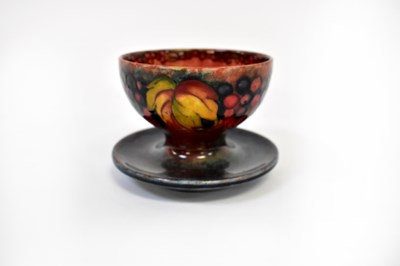 Lot 652 - MOORCROFT; a grape and vine pattern footed...