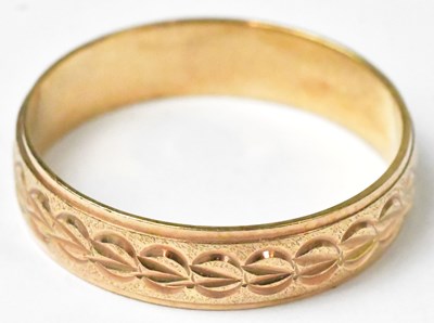 Lot 729 - A 9ct yellow gold wedding band with geometric...