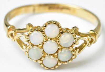 Lot 746 - A 9ct yellow gold flower head ring set with...