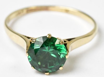 Lot 742 - A 9ct yellow gold ring set with a green stone,...
