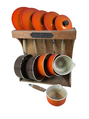 Lot 639 - LE CREUSET; a set of five graduated pans with...