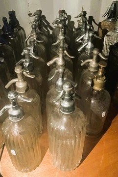 Lot 86 - Twenty glass soda syphons with metal or chrome...