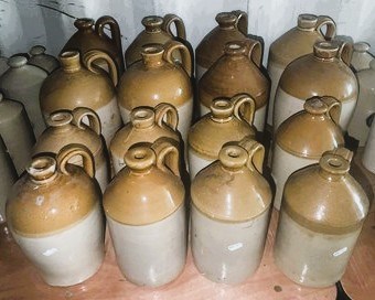 Lot 90 - Sixteen stoneware flagons of various shapes...