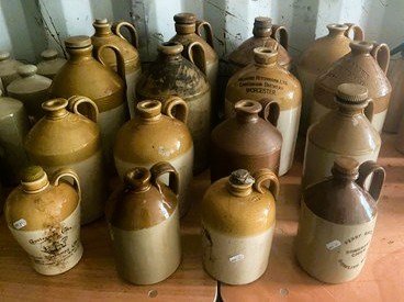 Lot 92 - Sixteen stoneware flagons of various shapes...