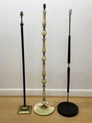 Lot 628 - A 1970s onyx and brass floor lamp, together...