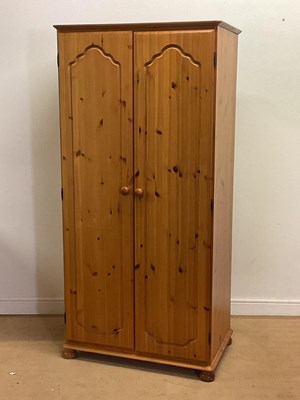 Lot 698 - A modern pine wardrobe with single rail and a...